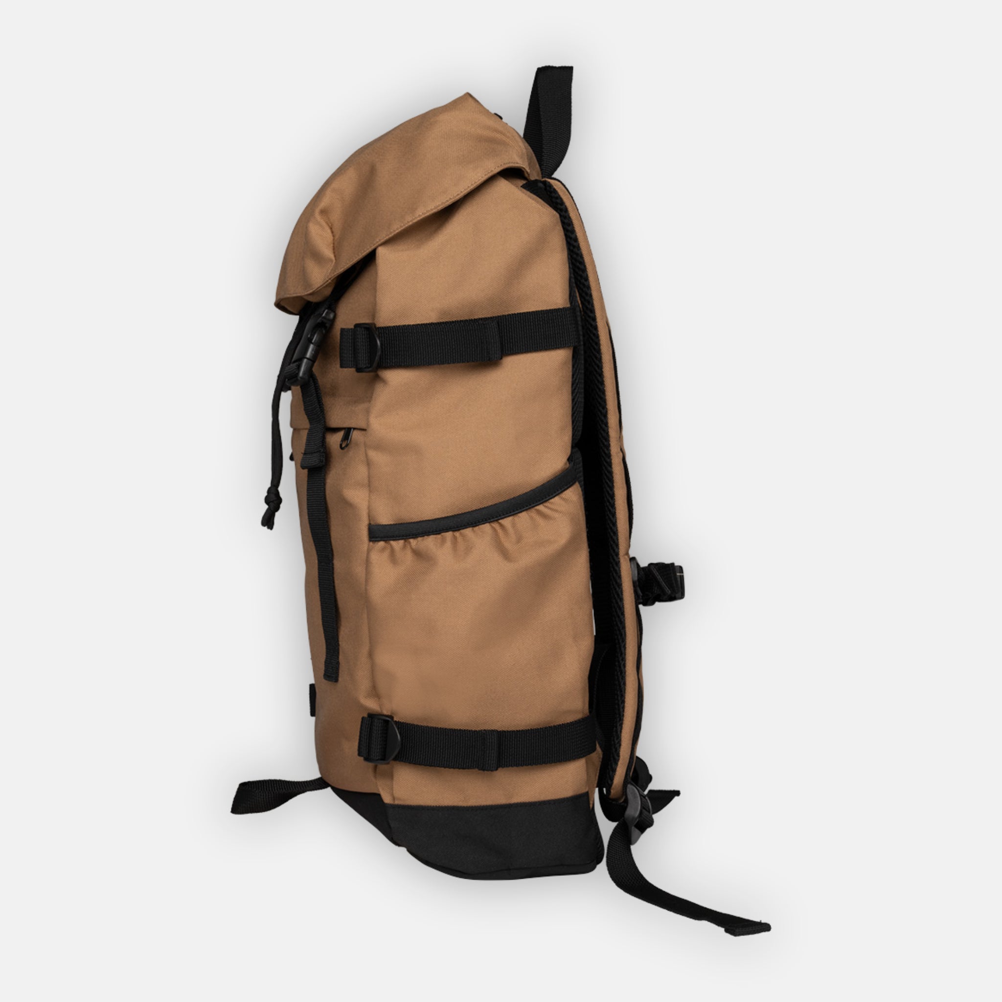 Side view of a deep camel coloured sustainable recycled backpack showing straps, carry handles, and external pocket for drinks. 