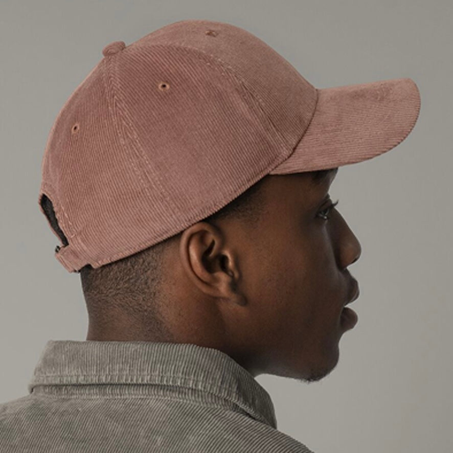 Man wearing a Redwood organic cotton corduroy cap and khaki organic cotton corduroy overshirt against a plain grey background.
