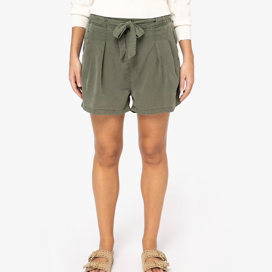Image shows a woman wearing our khaki women's Tencel bow shorts against a neutral background.